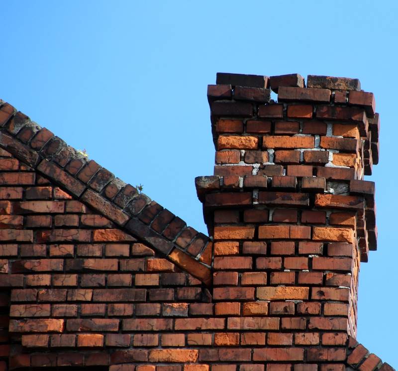 Signs Your Poolesville Home Needs a Chimney Inspection Damaged chimney on an Poolesville home showing cracks and missing mortar